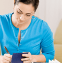 Woman writing in a checkbook