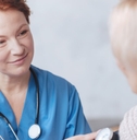 medical worker taking woman's blood pressure