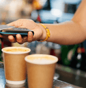 person scanning credit card at coffee shop