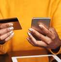 Woman using credit card on cellphone
