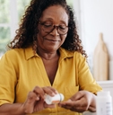 older woman taking prescription pills