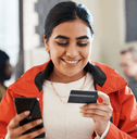 Woman using credit card on phone