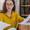 woman in eyeglasses holding paper bill letter at home