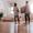 young couple standing in spacious lounge of new house holding moving boxes