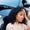 african american woman sitting on ground holding head in stress after having car accident