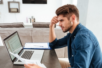 man looking at paperwork