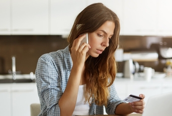woman calling to pay bills with credit card