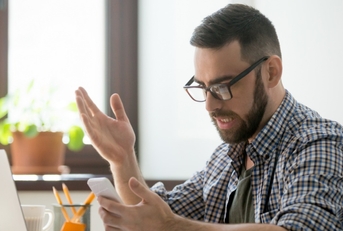 Confused man checking phone