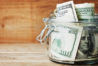 savings dollar in glass jar