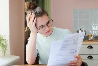 Woman looking confused at documents