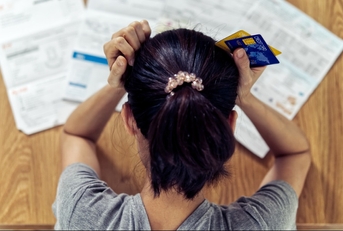 Stressed woman looking at bills