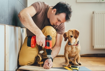 Man and dog with power tools