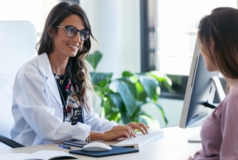 Woman talking to doctor