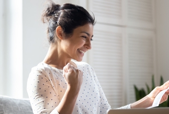 Happy woman looking at paperwork