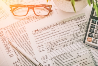 tax paperwork in a pike on a desk