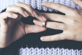 Woman removing wedding ring