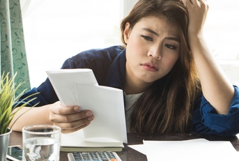 Woman Looking at Taxes