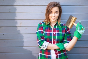 Woman painting house