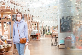 woman shopping in grocery store with mask
