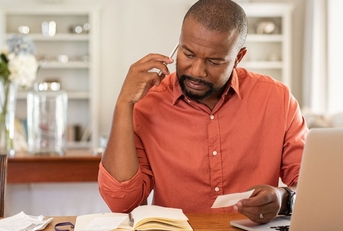 man looking at bills 