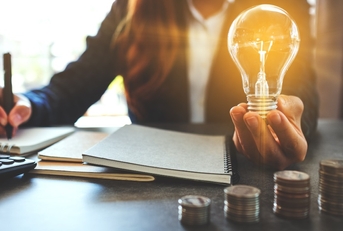 Woman holding light bulb