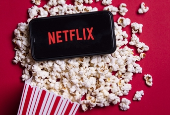 Netflix app on phone and popcorn