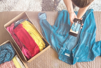 Person taking photos of clothes to resell