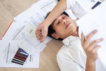 stressed man looking at bills