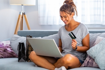 Woman using laptop and credit card