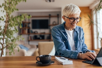 Smiling woman using computer