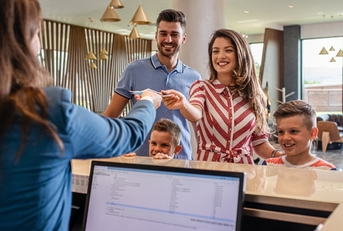 Family checking in at hotel