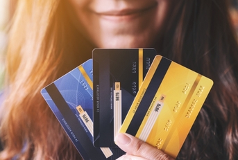 woman holding credit cards
