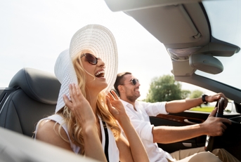 Couple riding in convertible