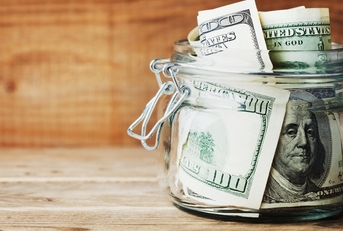 Jar filled with dollar bills