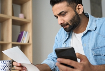 Man looking at check