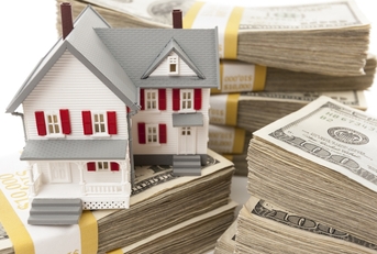 Toy house surrounded by money