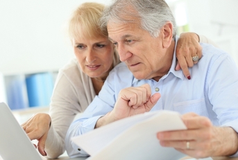 Older couple working on taxes on their computer