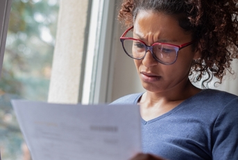 Worried woman looking at bills