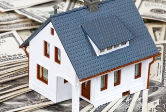 Model house sitting on money