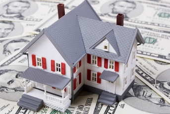 Model house sitting on money