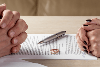 couple signing divorce paperwork