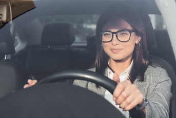 businesswoman looking ahead while driving car