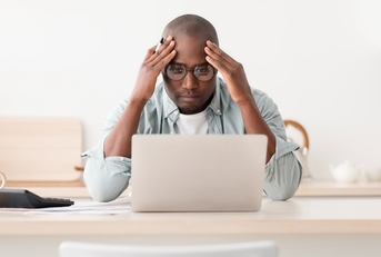 Worried man looking at computer