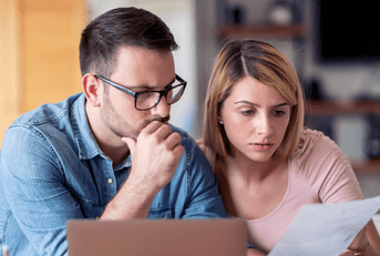 Worried couple looking at paperwork