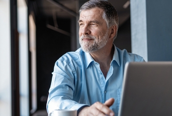 Mature businessman working on laptop