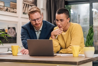 mixed races couple sitting in living room discussing