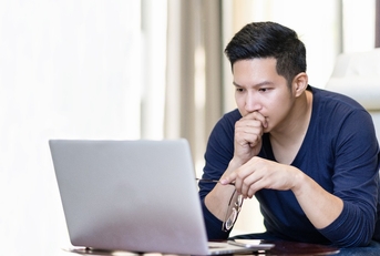 confident asian young freelancer in smart casual working