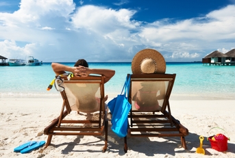 couple relaxing by the beach on a vacation