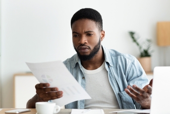 Man looking at bills