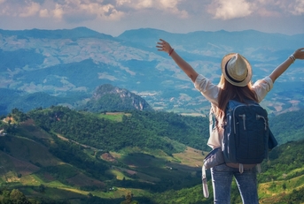 traveler girl standing with raised arms